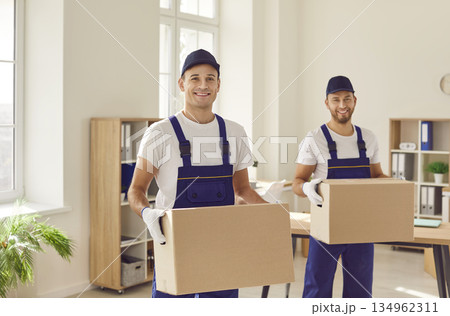 Smiling Movers with Cardboard Boxes during Relocation 134962311