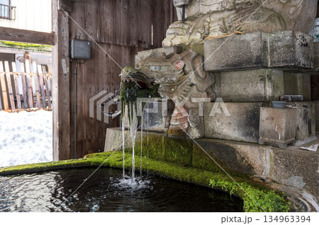 雪に包まれた寺院の手水舎と扁額|参拝前に心身を清める日本の伝統空間 雪に包まれた寺院の手水舎と扁額|参拝前に心身を清める日本の伝統空間 134963394