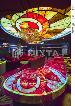 Las Vegas Casino Interior Vibrant Stained Glass Ceiling Modern Chandelier and Gaming Table Las Vegas Casino Interior Vibrant Stained Glass Ceiling Modern Chandelier and Gaming Table 134963495