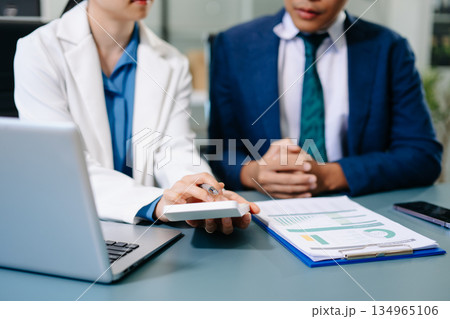 Team business meeting presentation. Hand businessman working project in modern office.Laptop computer and tablet and smart phone on white desk Team business meeting presentation. Hand businessman working project in modern office.Laptop computer and tablet and smart phone on white desk 134965106