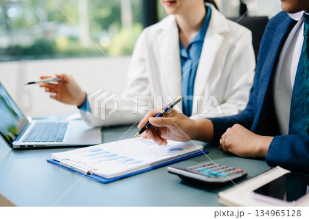Businessman and team analyzing financial statement Finance task. with smart phone and laptop and tablet. Wealth management concept. 134965128