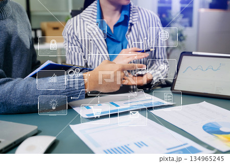 Working team meeting concept, business using laptop and smart phone and digital tablet computer with digital marketing media in virtual icon network diagram office Working team meeting concept, business using laptop and smart phone and digital tablet computer with digital marketing media in virtual icon network diagram office 134965245