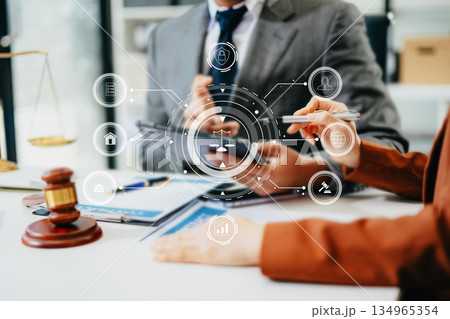 Business and lawyers discussing contract papers with brass scale on desk in office. Law, legal services, advice,  justice and law concept . 134965354