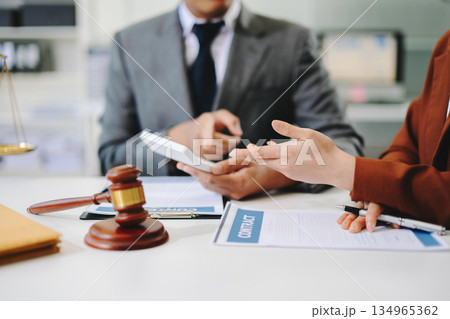 business people and lawyers discussing contract papers sitting at the table. Concepts of law, advice, legal services. business people and lawyers discussing contract papers sitting at the table. Concepts of law, advice, legal services. 134965362