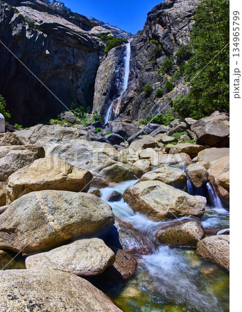 Lower Falls Trail Waterfall and Rocky Stream with Granite Cliffs in Bright Sunlight 134965799