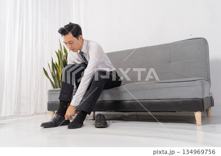 Professional man dressing for work in minimalist apartment 134969756