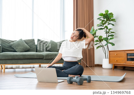 Young Asian woman stretching yoga workout on exercise mat Young Asian woman stretching yoga workout on exercise mat 134969768