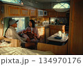 Engaging in a Cozy Conversation Inside of a Vintage Camper Trailer 134970176