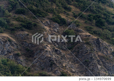 Slope of the mountain covered with rocks 134970699