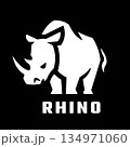 Rhinoceros silhouette logo on dark background. 134971060