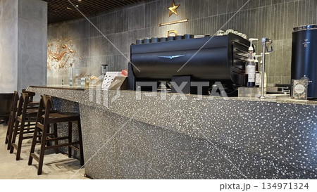 A sleek Starbucks Reserve counter with espresso machines, and holiday merchandise blends premium coffee culture 134971324