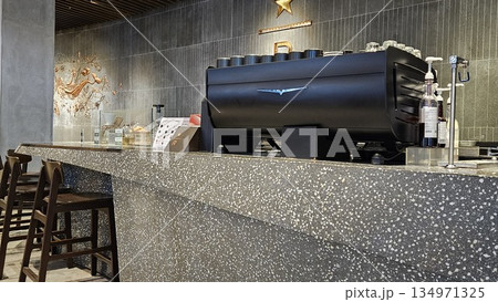 A sleek Starbucks Reserve counter with espresso machines, and holiday merchandise blends premium coffee culture 134971325