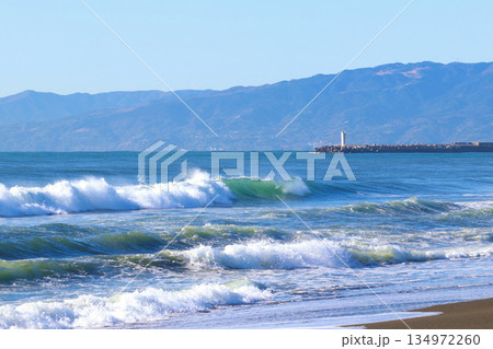 白波が立つ青い海と遠くに連なる山並みの海岸風景 白波が立つ青い海と遠くに連なる山並みの海岸風景 134972260