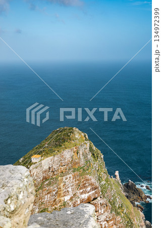 Cape of Good Hope cliff with a small white house by the blue atlantic ocean Cape of Good Hope cliff with a small white house by the blue atlantic ocean 134972399