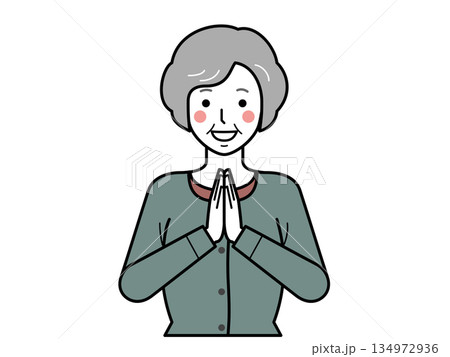 正面向き。いただきますと手を合わせるカーディガンを着た高齢女性。 134972936