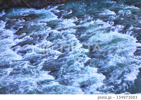 Rushing River Rapids with Blue Water and Vibrant White Foam in Banff Canada Rushing River Rapids with Blue Water and Vibrant White Foam in Banff Canada 134973083