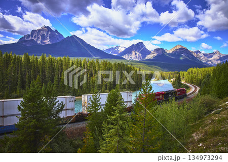Train Track and Cargo Train at Morant's Curve in Banff with Majestic Mountain Scenery 134973294