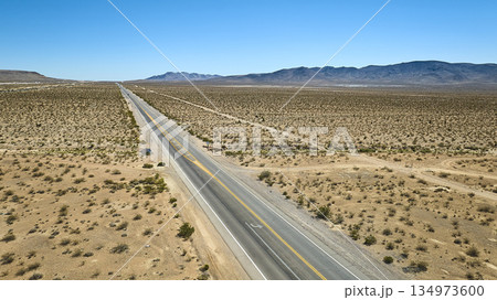 Aerial Nevada Desert Highway Vast Open Landscape and Distant Mountains 134973600