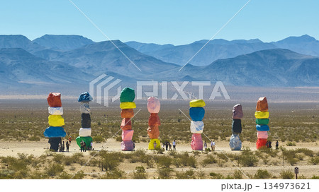 Seven Magic Mountains Art Installation Nevada Desert with Tourists and Distant Mountains Seven Magic Mountains Art Installation Nevada Desert with Tourists and Distant Mountains 134973621