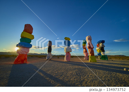 Seven Magic Mountains Colorful Rock Cairns with Sunburst and Desert Landscape Seven Magic Mountains Colorful Rock Cairns with Sunburst and Desert Landscape 134973752