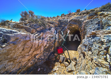 Abandoned Mine Entrance with Warning Sign and Desert Landscape in Nevada 134973781