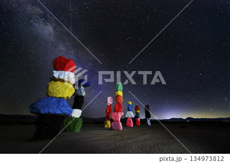 Seven Magic Mountains Vibrant Rock Cairns Under Starry Night Sky with Milky Way 134973812