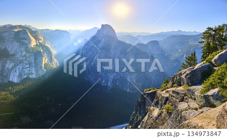 Panorama of Half Dome from Glacier Point with Sunbeam and Rugged Yosemite Cliffs Panorama of Half Dome from Glacier Point with Sunbeam and Rugged Yosemite Cliffs 134973847