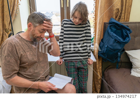 Stressed father helping son with difficult homework. Homeschooling and parenting challenges 134974217