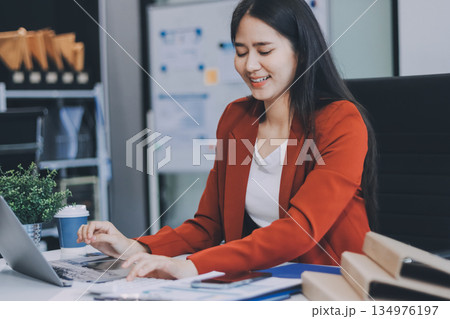 Asian business woman working on a laptop in a professional office 134976197