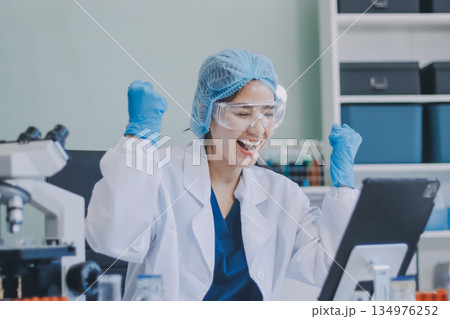 Portrait, science and happy woman on laptop in lab to research chemistry, test or innovation. Microscope, scientist and face of medical doctor in goggles for microbiology, healthcare or pharma study 134976252