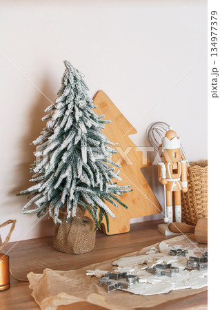 Christmas tree, baking background with cookie cutters, rolling pin and festive kitchen decor Christmas tree, baking background with cookie cutters, rolling pin and festive kitchen decor 134977379