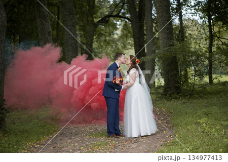 Bride And Groom Sharing Quiet Smoke Kiss Bride And Groom Sharing Quiet Smoke Kiss 134977413