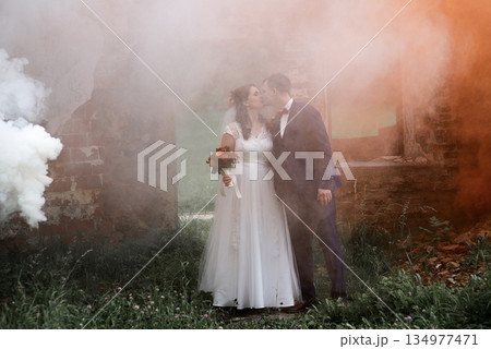 Wedding Couple Standing In Color Smoke Scene Wedding Couple Standing In Color Smoke Scene 134977471