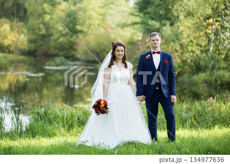 Young Bride And Groom Standing Together Portrait Young Bride And Groom Standing Together Portrait 134977636