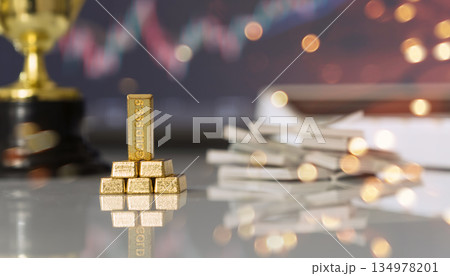 Gold bars and cash stacks with market backdrop Gold bars and cash stacks with market backdrop 134978201