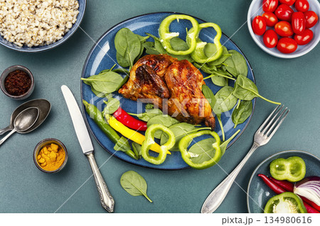 Half grilled chicken on the grill. 134980616