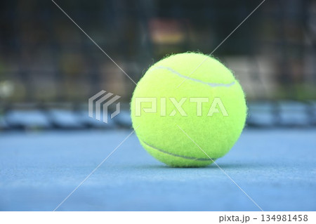 yellow tennis ball drop court with white border line on blue floor yellow tennis ball drop court with white border line on blue floor 134981458