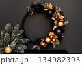 Sleek modern wreath in matte black and gold for stylish holiday decor 134982393