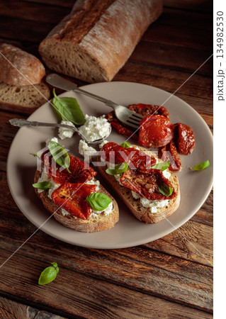 Ciabatta with sun dried tomatoes in olive oil, ricotta, and basil. Ciabatta with sun dried tomatoes in olive oil, ricotta, and basil. 134982530