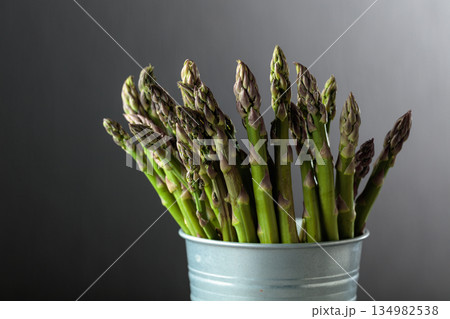 Fresh asparagus on a gray background. Fresh asparagus on a gray background. 134982538