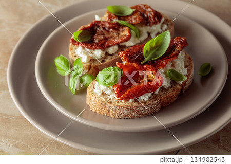 Ciabatta with sun dried tomatoes in olive oil, creamy cheese, and basil. Ciabatta with sun dried tomatoes in olive oil, creamy cheese, and basil. 134982543