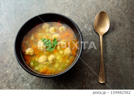 Classic meatball soup with potatoes, carrot and greens. Classic meatball soup with potatoes, carrot and greens. 134982562
