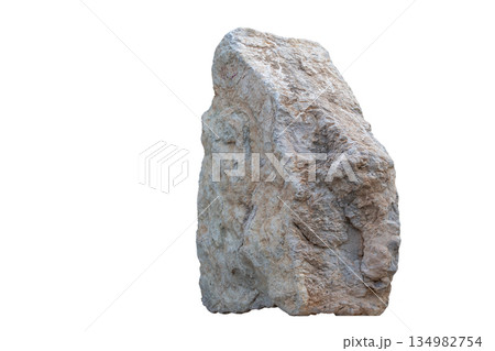 A large rock is sitting on a white background. The rock is grey and has a rough texture 134982754