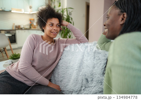 Mother and daughter talking, sharing a happy moment at home Mother and daughter talking, sharing a happy moment at home 134984778