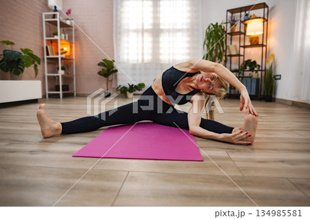 A person performs a yoga posture, embodying grace and focus A person performs a yoga posture, embodying grace and focus 134985581