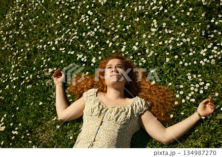 red curly hair beauty girl outdoors at spring season red curly hair beauty girl outdoors at spring season 134987270