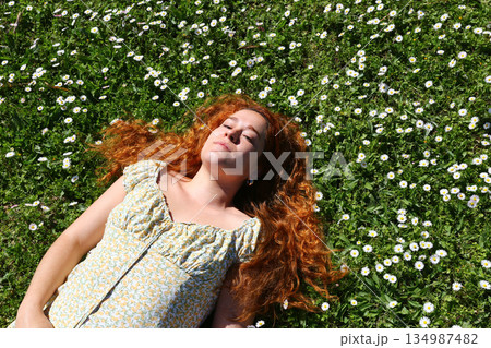 red curly hair beauty girl outdoors at spring season red curly hair beauty girl outdoors at spring season 134987482