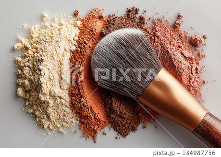 Universally flattering. Flat lay of makeup brush placed next to a color palette on white background. Universally flattering. Flat lay of makeup brush placed next to a color palette on white background. 134987756