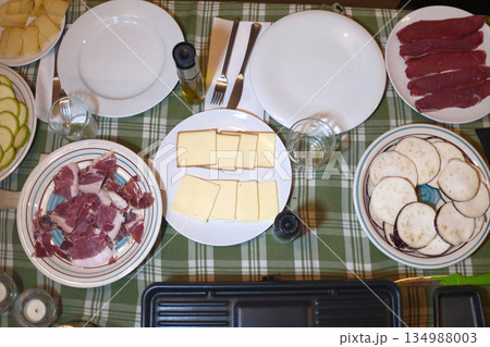 sliced cheese pieces for a traditional raclette lunch sliced cheese pieces for a traditional raclette lunch 134988003