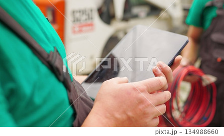 Electrical worker engineer a working with digital tablet, power near tower with electricity. energy business technology industry concept. electrical engineer studying reading on tablet Electrical worker engineer a working with digital tablet, power near tower with electricity. energy business technology industry concept. electrical engineer studying reading on tablet 134988660